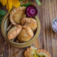Vegetarian Curry Puff · Pastry puff filled with potato, onion, carrot and yellow curry spices served with cucumber s...