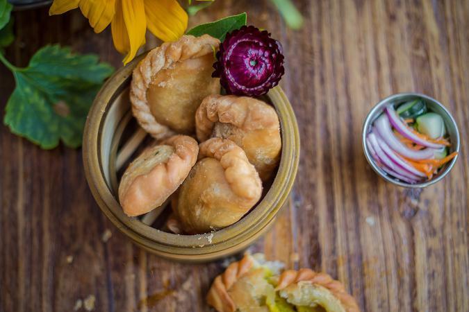 Vegetarian Curry Puff · Pastry puff filled with potato, onion, carrot and yellow curry spices served with cucumber salad