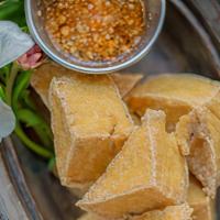 Tofu Triangles · Golden bean cake served with homemade sweet & sour sauce and crushed peanuts