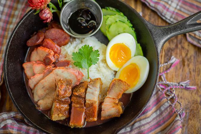 Kao Moo Dang · IThai 3 styles of pork, roasted pork, crispy pork belly, pork sausage and boiled egg over rice with homemade house gravy