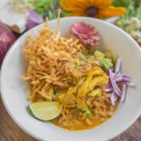 Khao Soi · Marinated beef or chicken with Northern-style red curry and egg noodles garnished with shall...