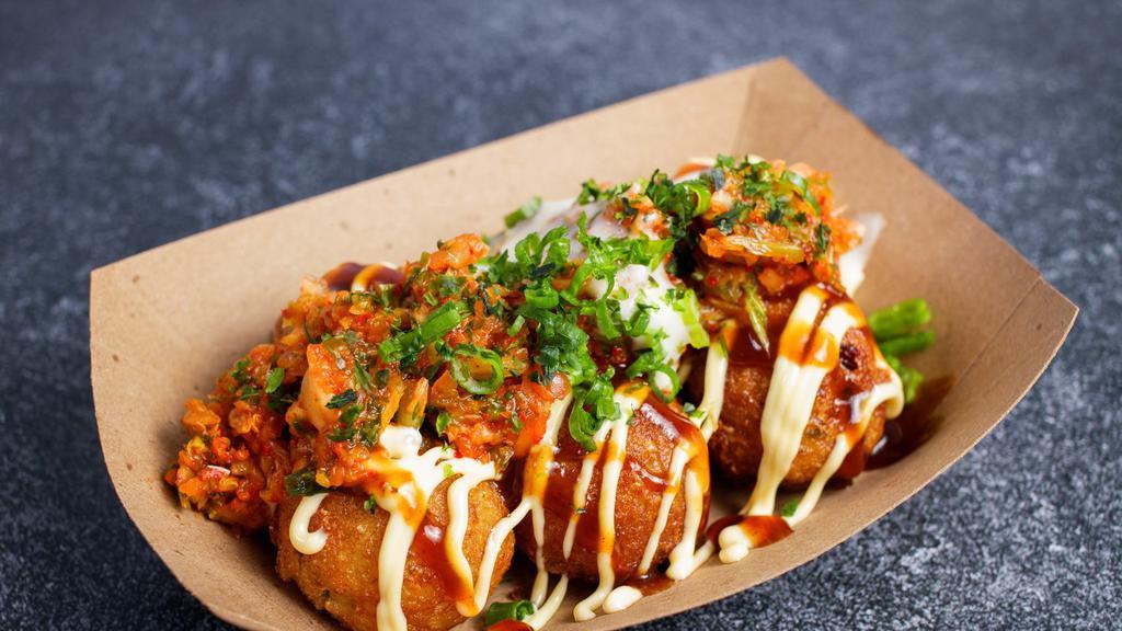 Kimchi Spicy Cheesy Takoyaki スパイシーキムチチーズたこ焼き · -6 pc of Japanese fried octopus balls topped with spicy kimchi, garlic cheesy sauce, scallion, mayonnaise, okonomiyaki sauce, seaweed flakes.