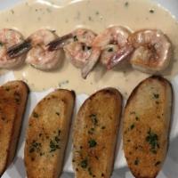 Scampi · Four Jumbo prawns sauteed in white wine, garlic and butter sauce with a touch of cream serve...