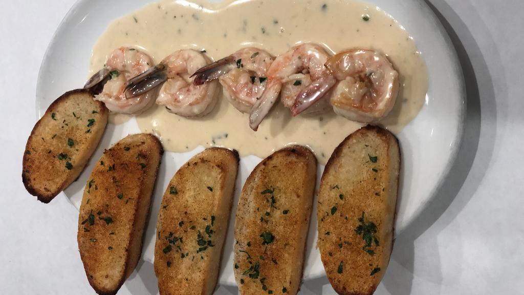 Scampi · Four Jumbo prawns sauteed in white wine, garlic and butter sauce with a touch of cream served with garlic toast.