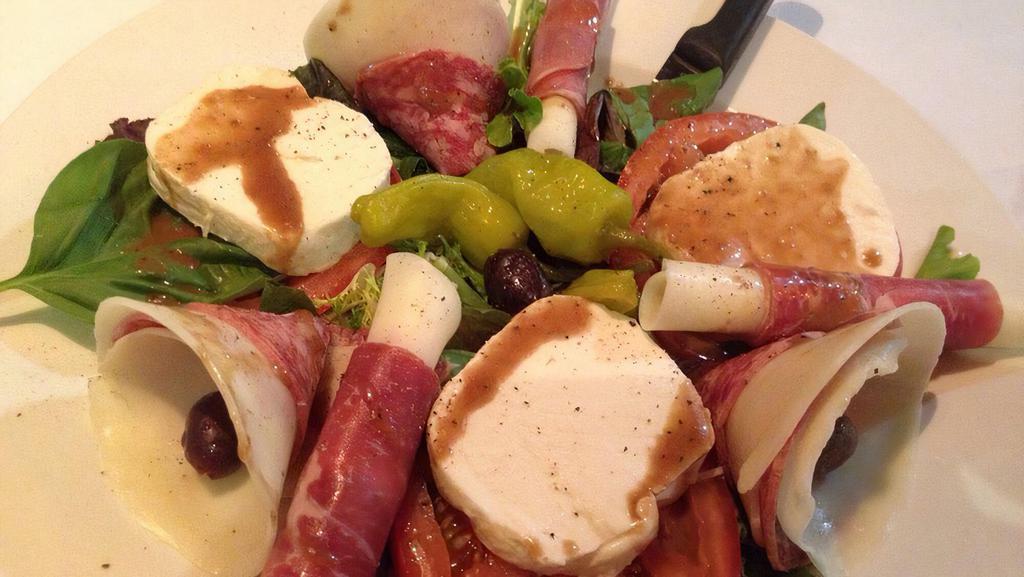 Antipasto Tradizionale · Prosciutto, salami, provolone cheese, fresh mozzarella, over Fresh tomatoes and olives with extra virgin olive oil and balsamic vinaigrette*.
*Dressing contains Raw Egg