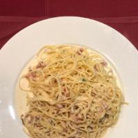 Pasta Carbonara · Spaghetti in alfredo sauce with bacon, red onions and egg added.