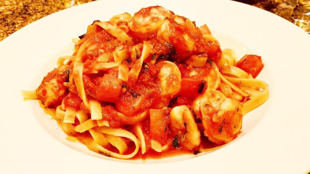 Shrimp Fiori · Fettuccine pasta sauteed with fresh tomatoes and baby prawns in a spicy red sauce.