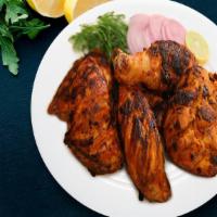 Charcoal Tandoori Chicken · Exotic chicken legs marinated in lemon juice, yogurt and aromatic spices