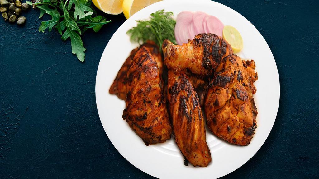 Charcoal Tandoori Chicken · Exotic chicken legs marinated in lemon juice, yogurt and aromatic spices