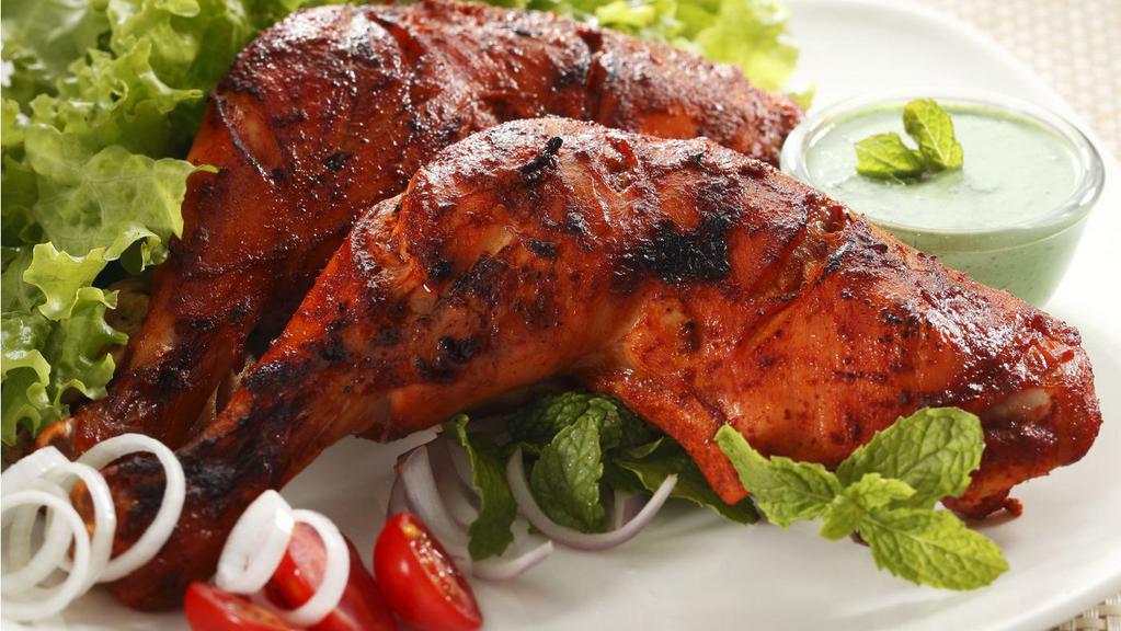 Charcoal Tandoori Chicken Whole (4 Pcs) · Whole chicken marinated in yogurt with special herbs, spices and cooked in tandoor - ( 4 pcs: 2 leg, 2breast with wings)
