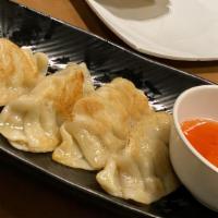 7. Chicken Pot Stickers · Chicken filling and vegetables in wonton wraps served with sweet and sour sauce.