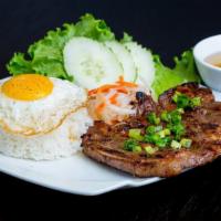 8. Lemongrass Pork Chop · Grilled pork chop and fried egg served with rice, lettuce, cucumber, veggie pickles and fish...