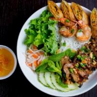 25. Combination Bún · Combination of grilled shrimps, grilled pork, pork eggroll vermicelli noodle served with let...