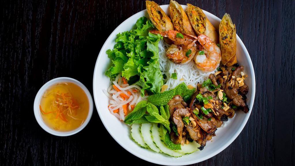 25. Combination Bún · Combination of grilled shrimps, grilled pork, pork eggroll vermicelli noodle served with lettuce, cucumber, pickled daikon & carrot, Asian herbs, and Nuoc Cham (fish sauce vinaigrette)