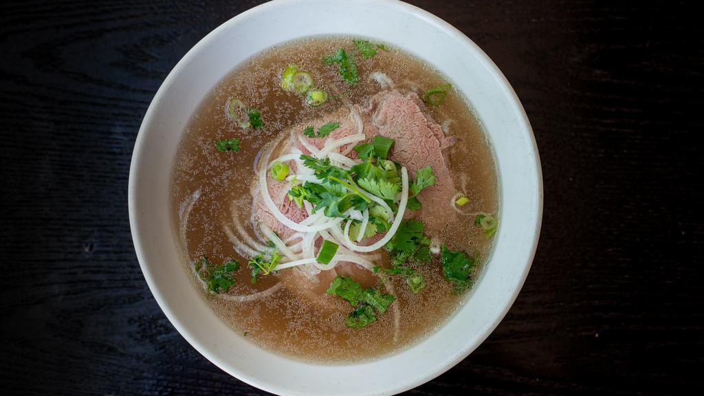 23. Rare Steak Phở · Rice noodle served in beef broth with rare steak slices.