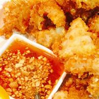 Crispy Calamari · Crispy deep-fried calamari with sweet and sour sauce topped with crushed peanut.