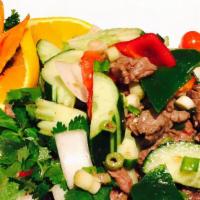 Beef Salad · Grilled sliced beef, cucumber, bell pepper, onion, and mint served with spicy lime dressing.