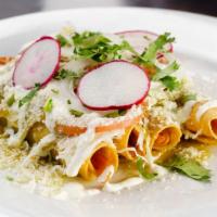 Taquitos de Pollo · Hand rolled fried tacos stuffed with chicken, topped with cabbage slaw, cheese, sour cream. ...