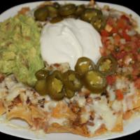 Nachos · Corn Tortilla Chips, Melted Cheese, Refried Beans, Fresh Salsa, Jalapenos, Sour Cream, and G...