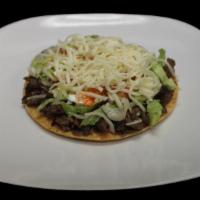 Tostada · Choice of Meat, Beans, Lettuce, Guacamole, Sour Cream, Cheese, and Salsa