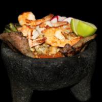 Molcajete · Shrimp. chicken, steak, cactus, green onion, radishes and salsa