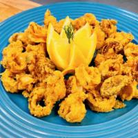 Calamari · Golden fried calamari rings served with lemon, marinara, mayo aioli sauce.