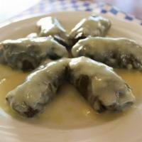 Dolmades · A portion of (6)Tender grape leaves stuffed with rice and beef, topped with egg-lemon sauce.