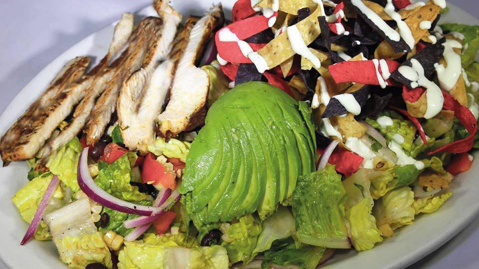 Chicken Mexican Salad · Romaine lettuce, onion, black beans, bell pepper, grilled corn, fried tortilla, cilantro, avocado, spiced sour cream, and house dressing.