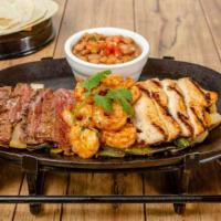 IGNITED FAJITAS SUPREMAS · Our premium fajitas with ancho-chile marinated sirloin steak, chicken breast and sautéed shr...