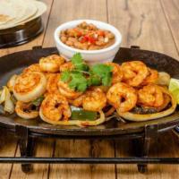 SHRIMP FAJITAS · Tender shrimp sautéed in jalapeño-garlic butter and guajillo chile sauce. Served with rice, ...
