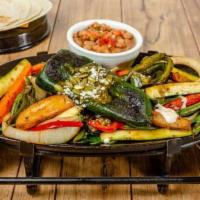 Veggie Fajitas · Fresh vegetables, rosemary and mint leaves with a grilled chile relleno. Served with rice, f...