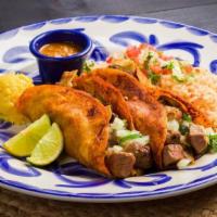 Fajita Tacos · Two tortillas lightly basted with guajillo sauce, filled with marinated chicken or sirloin s...