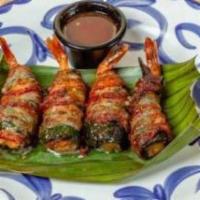 BACON WRAPPED SHRIMP · Four large grilled shrimp wrapped in roasted pasilla chiles, manchego cheese and bacon.