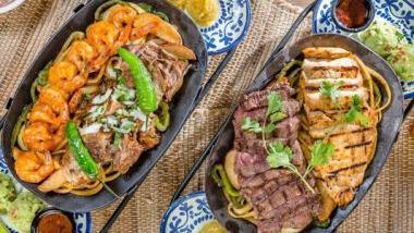 Family Style Fajitas · Steak, large shrimp, chicken and carnitas fajitas served with rice, refried beans, guacamole, sweet corn cake and choice of tortillas.