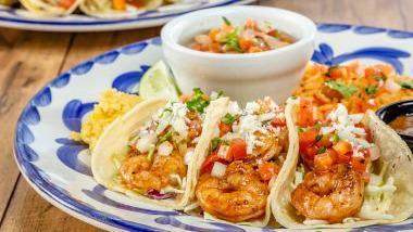 Seafood Taco Trio · Three grilled or Dos Equis beer battered mahi-mahi or shrimp tacos served with frijoles de la olla and rice.