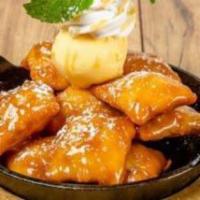 SOPAPILLAS · Mexican pastry tossed in caramel sauce and topped with vanilla ice cream and cinnamon whippe...