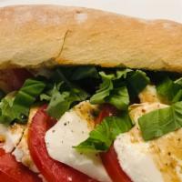 The Caprese Sandwich · Fresh mozzarella, tomato, basil with salt and pepper, oil and vinegar.