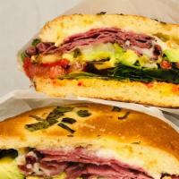 The Milanese Sandwich · Pastrami, provolone cheese, roasted red peppers, pesto sauce and works.