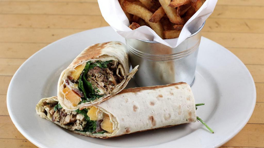 Jerk Chicken Lavash · Roasted Chicken Thigh with Jamaican Seasonings, Mangoes, Spinach, Caramelized Onions, Capers and Jerk Mayonnaise wrapped in Lavash Bread and
Served with a House salad or French Fries.