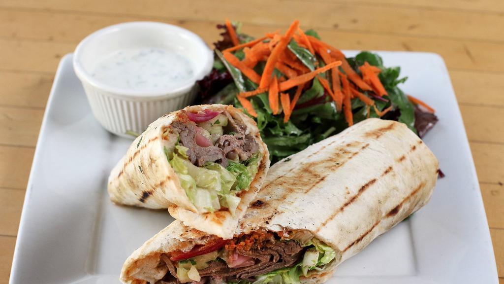 Lamb Shawarma · Wrapped in Homemade Flat Bread with Cucumbers, Tomatoes, Pickled Onions, Shredded Lettuce, Tahini Sauce and a Red Bell Pepper/Eggplant Spread and
Served with a Cucumber Yogurt Sauce and choice of a House salad or French fries.