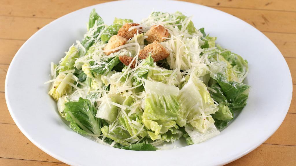 Caesar Salad · Romaine Hearts with Caesar Dressing, Parmesan Cheese and Croutons.