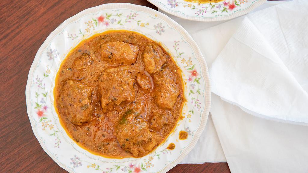 Chicken Karahi · Northwestern and Himalayan region specialty. Diced chicken cooked with northern spices, herbs and tomatoes in traditional style.