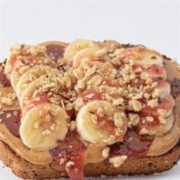 Pb & Chia Jam Toast · Whole Grain Bread, Peanut Butter, Sliced Banana, Strawberry Chia Jam, Granola.