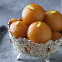 Gulab Jamun · Traditional donut hole served in a sweet syrup.