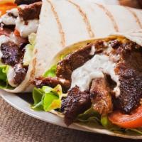 Steak et Fromage wrap · Marinated and grilled sliced steak with aioli, roasted red peppers, fresh onions, cheddar ch...