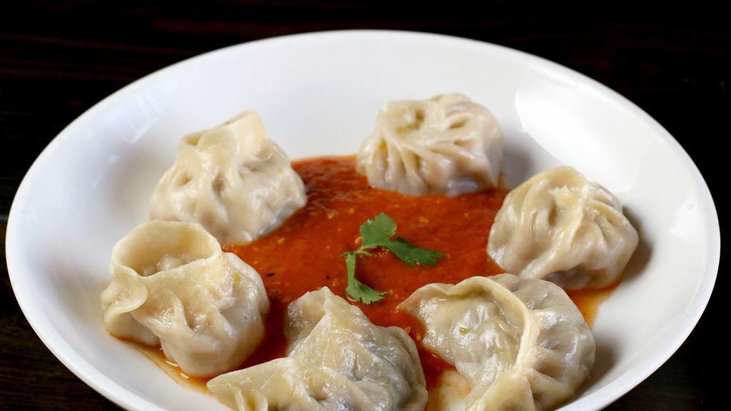 Momo · Most popular. Eight pieces. Steamed vegetables, all-natural ground chicken or beef dumplings, chilled tomato chutney.