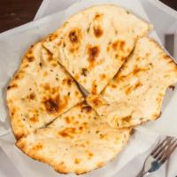 #71. Plain Naan · Traditionally baked bread in the tandoor oven.