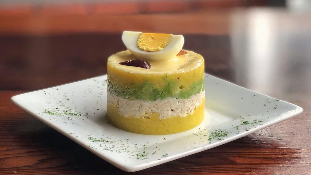 CAUSA · whipped yellow potatoes seasoned and layered with avocado, lime and Peruvian yellow pepper.