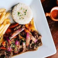 LOMO SALTADO · Sauteed grass fed filet mignon strips with onions, tomatoes, french fries served with rice