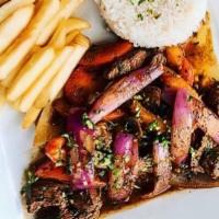 LOMO SALTADO · sautéed grass-fed sirloin strips with onions, tomatoes, French fries with rice.